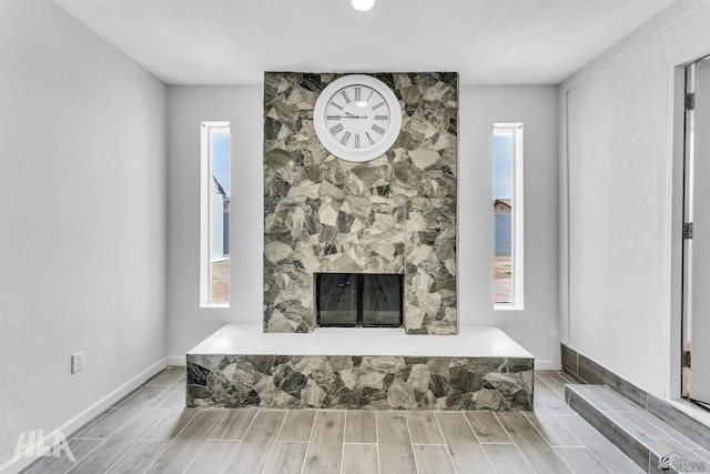 1721 S Athens Ave, Yuma, AZ 85364 - detailed view of wood tiled floors, a stone fireplace, and baseboards