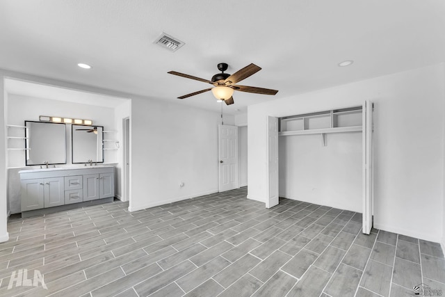 1721 S Athens Ave, Yuma, AZ 85364 - unfurnished bedroom with recessed lighting, light wood finished floors, a closet, a sink, and baseboards