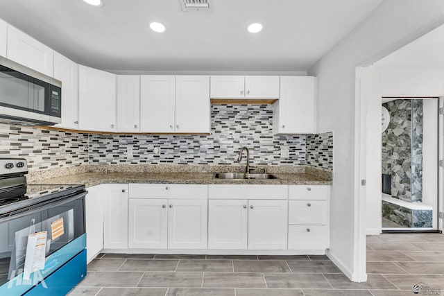 1721 S Athens Ave, Yuma, AZ 85364 - kitchen with a sink, appliances with stainless steel finishes, white cabinetry, stone counters, and recessed lighting