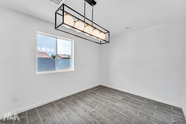 1721 S Athens Ave, Yuma, AZ 85364 - empty room with baseboards, wood tiled floors, and a smoke detector