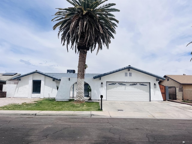 1721 S Athens Ave, Yuma, AZ 85364 - view of front facade featuring an attached garage, concrete driveway, a gate, and stucco siding