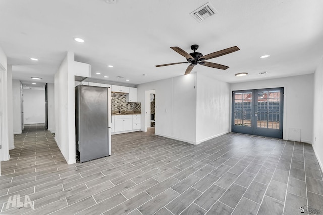 1721 S Athens Ave, Yuma, AZ 85364 - unfurnished living room with french doors, baseboards, a ceiling fan, recessed lighting, and light wood finished floors
