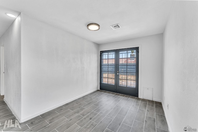 1721 S Athens Ave, Yuma, AZ 85364 - unfurnished room with french doors, wood tiled floors, and baseboards