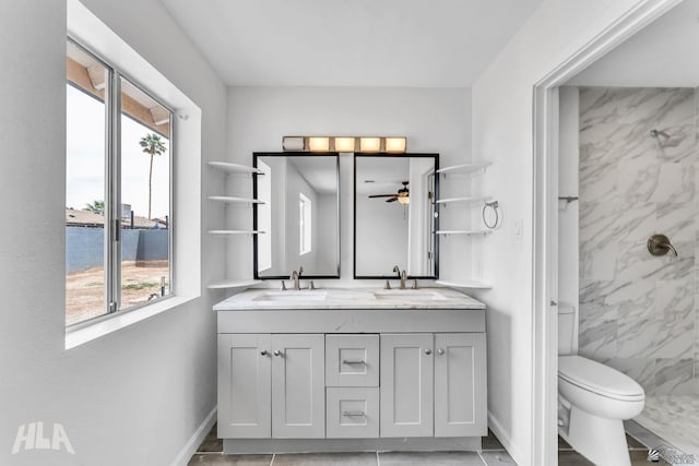 1721 S Athens Ave, Yuma, AZ 85364 - full bath with double vanity, a shower, a ceiling fan, baseboards, and toilet