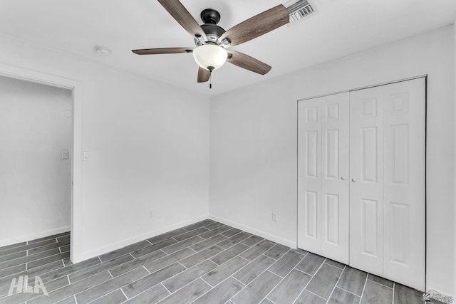 1721 S Athens Ave, Yuma, AZ 85364 - unfurnished bedroom with wood finish floors, a closet, a ceiling fan, and baseboards