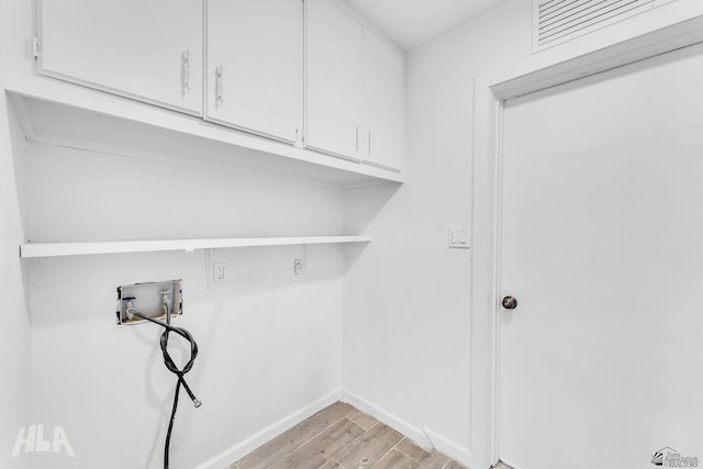 1721 S Athens Ave, Yuma, AZ 85364 - washroom featuring cabinet space, light wood-style floors, washer hookup, and baseboards