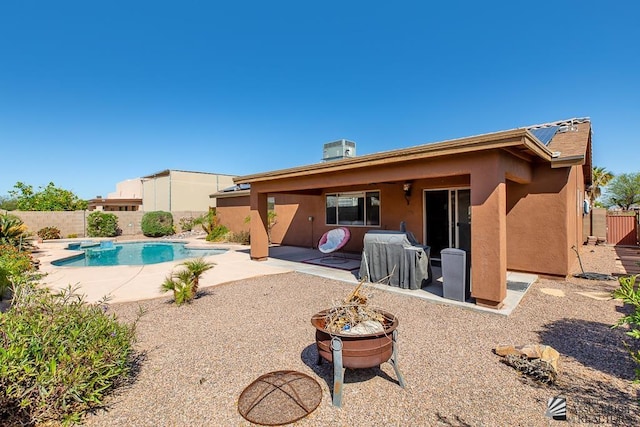 11861 E Eclipse Ct, Yuma, AZ 85367 - rear view of house with stucco siding, a fenced in pool, a fenced backyard, a patio area, and a fire pit