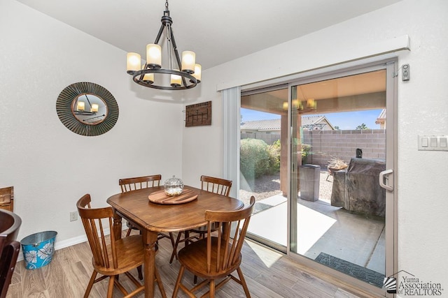 11861 E Eclipse Ct, Yuma, AZ 85367 - dining area featuring baseboards, wood finished floors, and a chandelier