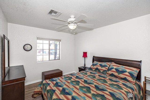 11861 E Eclipse Ct, Yuma, AZ 85367 - bedroom with visible vents, baseboards, a textured ceiling, and wood finished floors