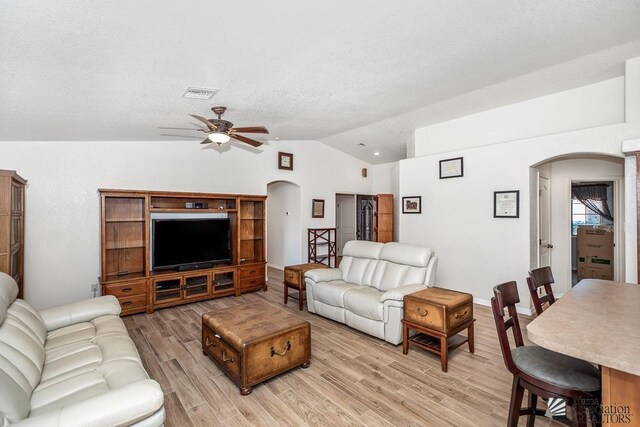 11861 E Eclipse Ct, Yuma, AZ 85367 - living area with visible vents, a ceiling fan, light wood-style floors, arched walkways, and vaulted ceiling
