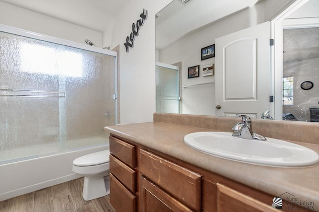 11861 E Eclipse Ct, Yuma, AZ 85367 - bathroom featuring vanity, enclosed tub / shower combo, wood finished floors, and toilet