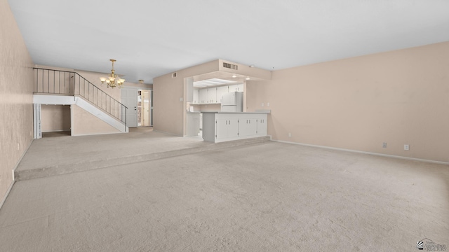 1440 E Laguna Pl, Yuma, AZ 85365 - unfurnished living room featuring a chandelier, baseboards, and light carpet