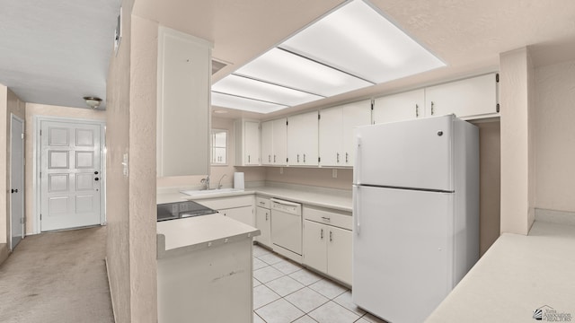 1440 E Laguna Pl, Yuma, AZ 85365 - kitchen featuring white appliances, light countertops, white cabinets, a sink, and light tile patterned floors