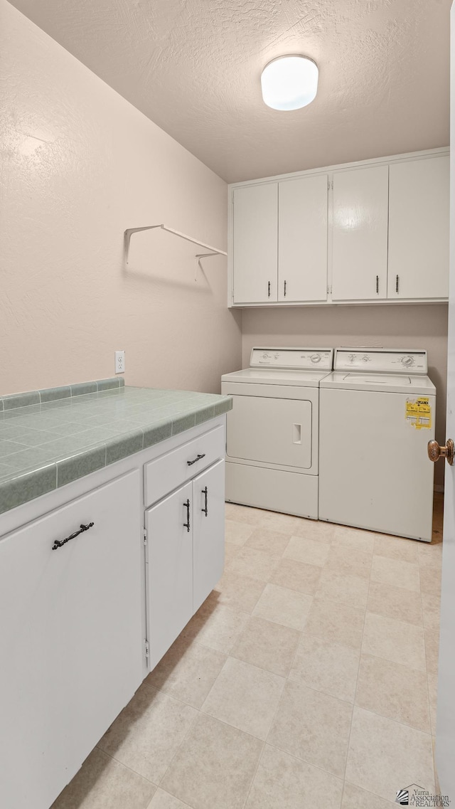 1440 E Laguna Pl, Yuma, AZ 85365 - clothes washing area featuring cabinet space, washing machine and dryer, and a textured ceiling