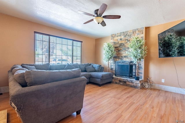 2931 W 20th St, Yuma, AZ 85364 - living area featuring a fireplace, ceiling fan, wood finished floors, and a textured ceiling