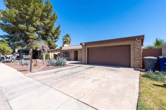 2931 W 20th St, Yuma, AZ 85364 - view of front of house with stucco siding, concrete driveway, a garage, and a chimney