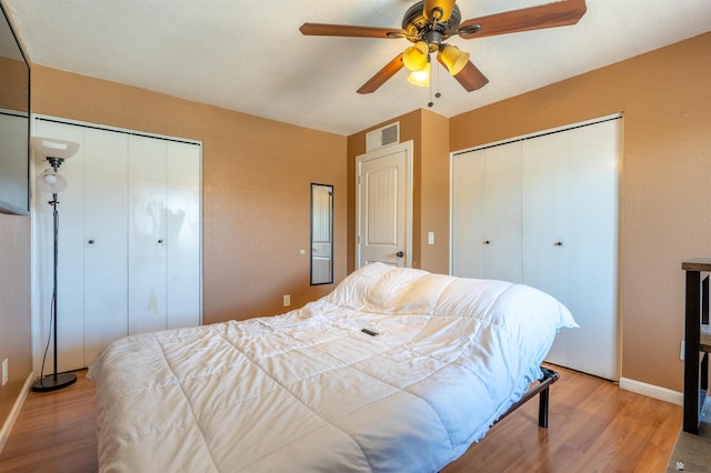 2931 W 20th St, Yuma, AZ 85364 - bedroom featuring multiple closets, wood finished floors, baseboards, and a ceiling fan