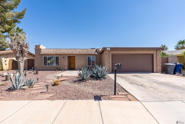 2931 W 20th St, Yuma, AZ 85364 - view of front of property with stucco siding, an attached garage, and driveway