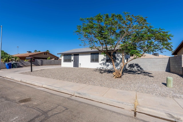 view of front of house featuring fence and stucco siding