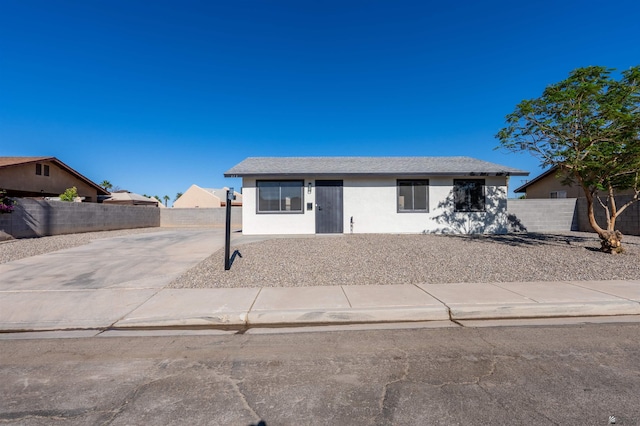 view of front of property with fence and stucco siding