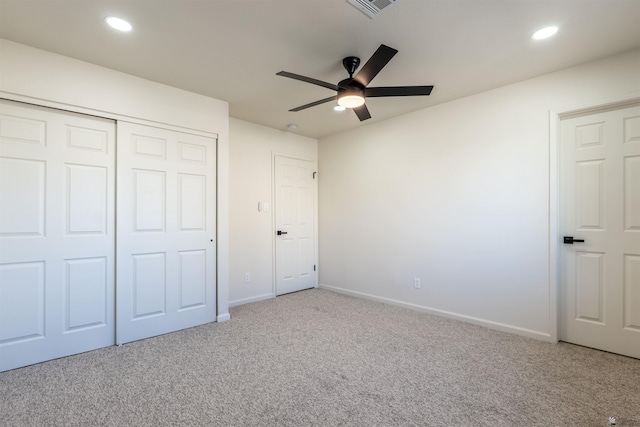 unfurnished bedroom featuring recessed lighting, carpet flooring, baseboards, and a closet