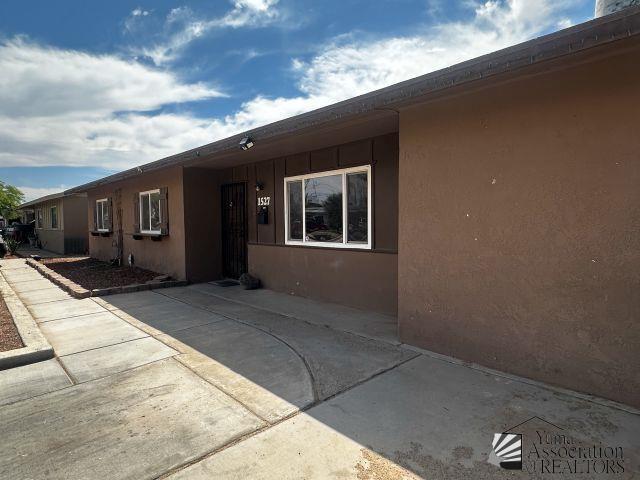1527 E 23rd St, Yuma, AZ 85364 - property entrance with a patio area and stucco siding