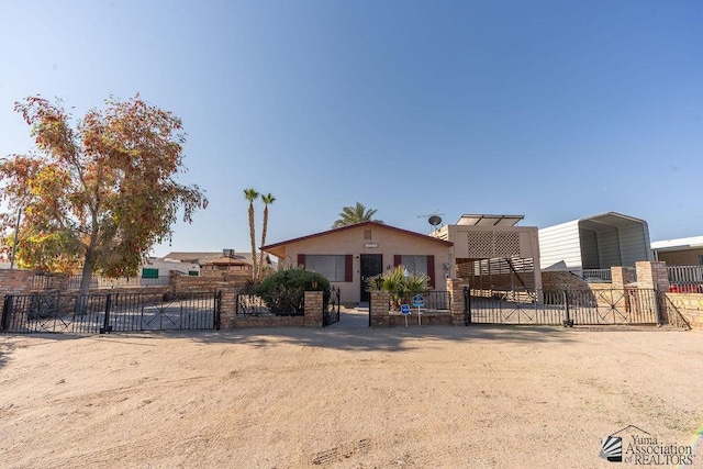 13125 E 51st Ln, Yuma, AZ 85367 - view of front of house featuring stucco siding, fence private yard, a gate, and a carport