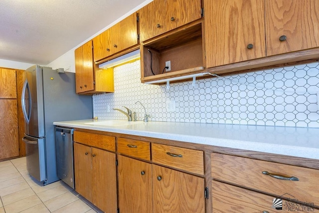 13125 E 51st Ln, Yuma, AZ 85367 - kitchen with stainless steel dishwasher, decorative backsplash, light countertops, a sink, and light tile patterned floors