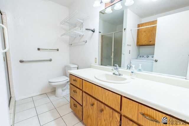 13125 E 51st Ln, Yuma, AZ 85367 - bathroom featuring tile patterned flooring, vanity, toilet, washer / clothes dryer, and a shower stall