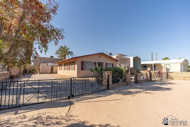 13125 E 51st Ln, Yuma, AZ 85367 - view of front facade with fence private yard, a gate, and stucco siding