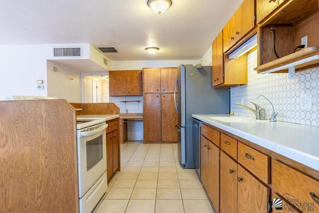 13125 E 51st Ln, Yuma, AZ 85367 - kitchen with light countertops, electric range, backsplash, and brown cabinets