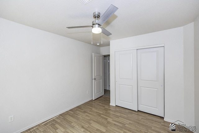 11760 E 28th Pl, Yuma, AZ 85367 - unfurnished bedroom with baseboards, light wood-style flooring, ceiling fan, and a closet