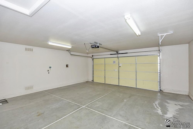 11760 E 28th Pl, Yuma, AZ 85367 - garage featuring baseboards, a garage door opener, and visible vents