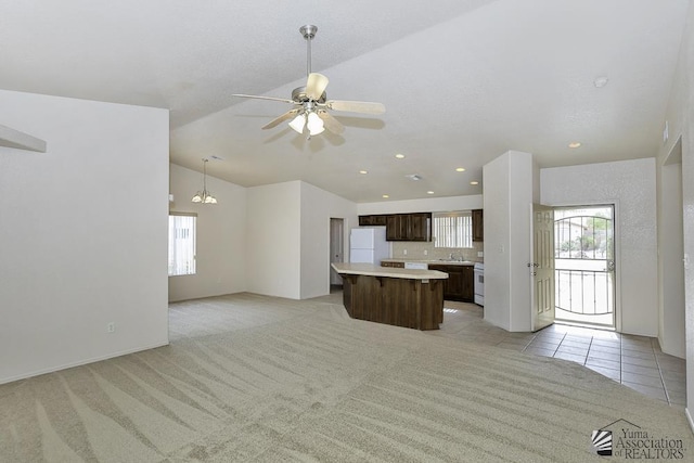 11760 E 28th Pl, Yuma, AZ 85367 - kitchen with dark brown cabinetry, a center island, light countertops, open floor plan, and white appliances