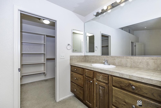 11760 E 28th Pl, Yuma, AZ 85367 - bathroom with a walk in closet and vanity