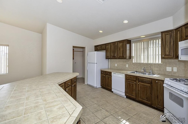 11760 E 28th Pl, Yuma, AZ 85367 - kitchen with a sink, decorative backsplash, tile countertops, and white appliances