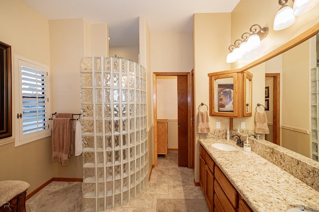 1009 S Tamarack Ave, Yuma, AZ 85364 - bathroom featuring vanity, baseboards, and walk in shower