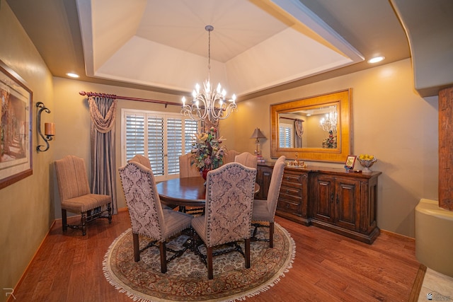 1009 S Tamarack Ave, Yuma, AZ 85364 - dining area featuring a healthy amount of sunlight, a raised ceiling, wood finished floors, and a chandelier