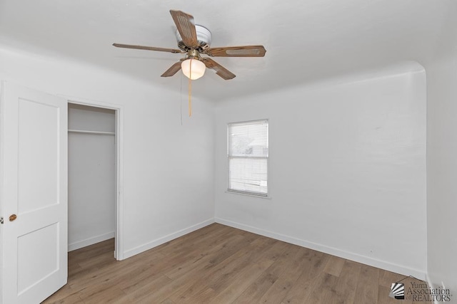 185 S 5th Ave, Yuma, AZ 85364 - unfurnished bedroom featuring wood finished floors, baseboards, a closet, and a ceiling fan