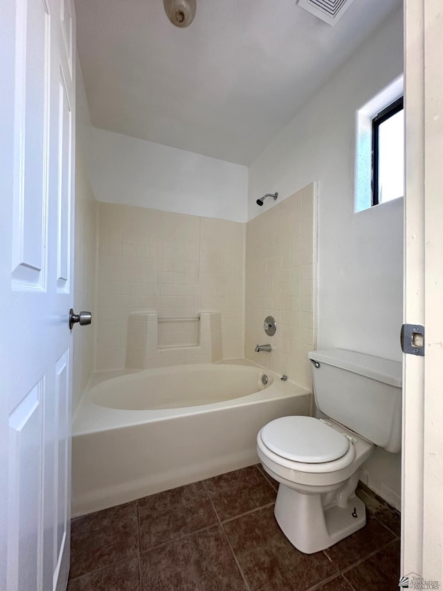 bathroom featuring shower / bathtub combination, toilet, visible vents, and tile patterned flooring