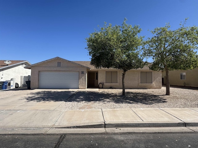 6348 E 45th St, Yuma, AZ 85365 - view of front of house featuring a garage, stucco siding, and concrete driveway
