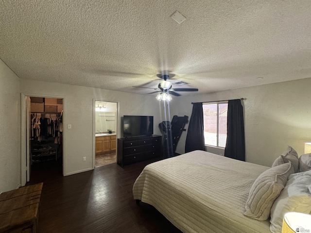 6348 E 45th St, Yuma, AZ 85365 - bedroom with dark wood-style flooring, a spacious closet, a textured ceiling, a closet, and ceiling fan