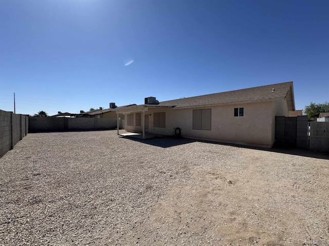 6348 E 45th St, Yuma, AZ 85365 - rear view of property with stucco siding and a fenced backyard