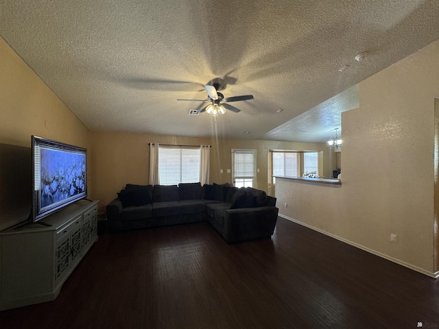 6348 E 45th St, Yuma, AZ 85365 - living room with dark wood-style floors, a ceiling fan, a textured ceiling, baseboards, and plenty of natural light