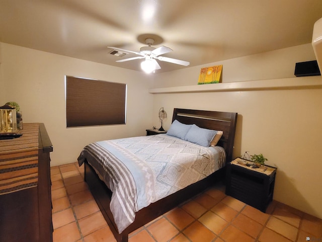 bedroom with tile patterned flooring, ceiling fan, and visible vents