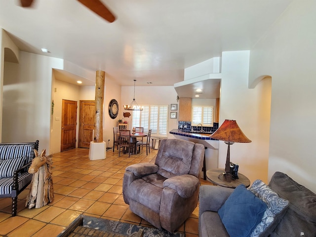 living room with light tile patterned floors, arched walkways, and recessed lighting