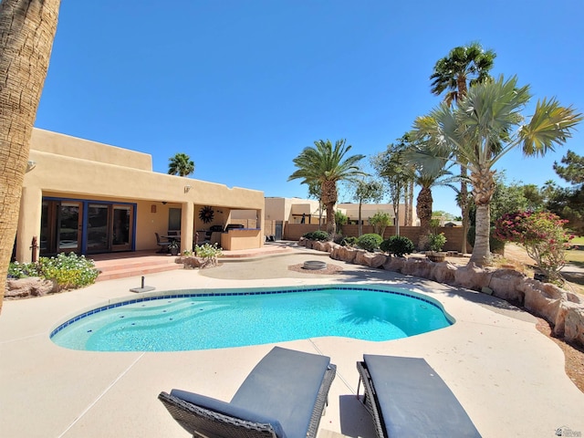 view of pool with a fenced in pool, fence, and a patio