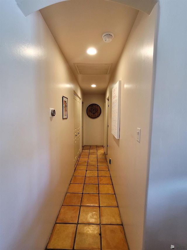 corridor featuring visible vents and attic access