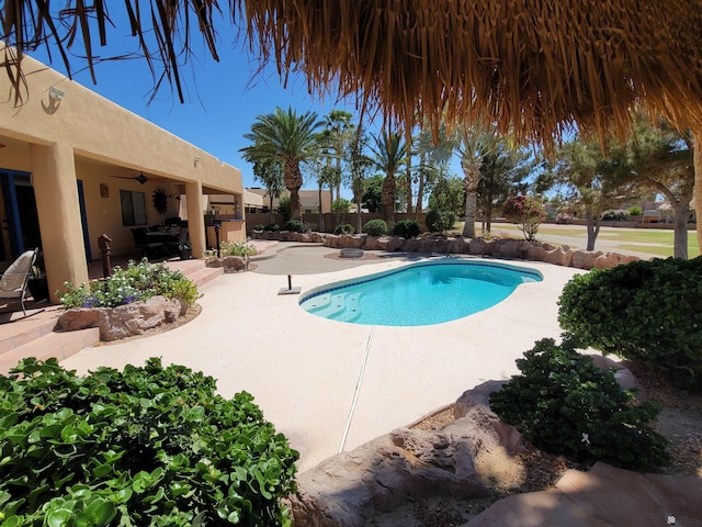 view of swimming pool featuring a fenced in pool, a ceiling fan, a patio area, and fence