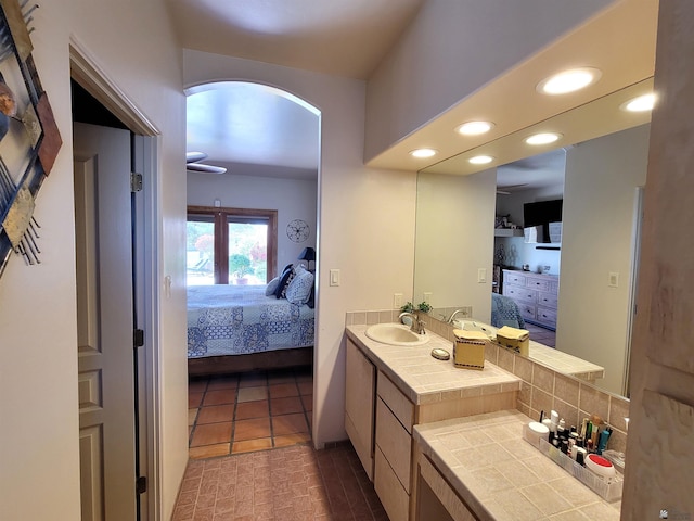 bathroom with recessed lighting, vanity, tasteful backsplash, and ensuite bath